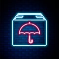 Glowing neon line Delivery package with umbrella symbol icon isolated on brick wall background. Parcel cardboard box Royalty Free Stock Photo