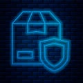 Glowing neon line Delivery security with shield icon isolated on brick wall background. Delivery insurance. Insured Royalty Free Stock Photo