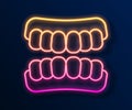 Glowing neon line Dentures model icon isolated on black background. Teeth of the upper jaw. Dental concept. Vector