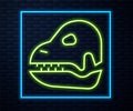 Glowing neon line Dinosaur skull icon isolated on brick wall background. Vector