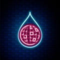 Glowing neon line Earth planet in water drop icon isolated on brick wall background. World globe and water drop. Saving Royalty Free Stock Photo