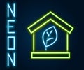 Glowing neon line Eco friendly house icon isolated on black background. Eco house with leaf. Colorful outline concept Royalty Free Stock Photo
