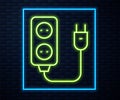 Glowing neon line Electric extension cord icon isolated on brick wall background. Power plug socket. Vector Royalty Free Stock Photo