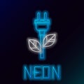 Glowing neon line Electric saving plug in leaf icon isolated on black background. Save energy electricity icon