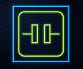 Glowing neon line Electrolytic capacitor icon isolated on brick wall background. Vector