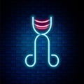 Glowing neon line Eyelash curler icon isolated on brick wall background. Makeup tool sign. Colorful outline concept