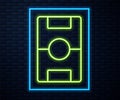 Glowing neon line Football table icon isolated on brick wall background. Hockey table. Vector