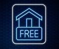 Glowing neon line Free home delivery concept for increase the sell stock icon isolated on brick wall background. Vector
