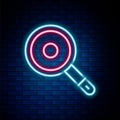 Glowing neon line Frying pan icon isolated on brick wall background. Fry or roast food symbol. Colorful outline concept