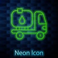 Glowing neon line Fuel tanker truck icon isolated on brick wall background. Gasoline tanker. Vector