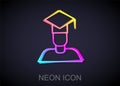 Glowing neon line Graduate and graduation cap icon isolated on black background. Vector