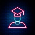 Glowing neon line Graduate and graduation cap icon isolated on brick wall background. Colorful outline concept. Vector
