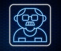 Glowing neon line Grandfather icon isolated on brick wall background. Vector