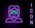 Glowing neon line Hacker or coder icon isolated on black background. Programmer developer working on code, coding Royalty Free Stock Photo