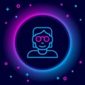 Glowing neon line Hacker or coder icon isolated on black background. Programmer developer working on code, coding Royalty Free Stock Photo