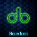 Glowing neon line Handcuffs icon isolated on brick wall background. Vector