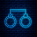 Glowing neon line Handcuffs icon isolated on brick wall background. Vector Illustration