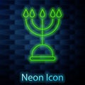 Glowing neon line Hanukkah menorah icon isolated on brick wall background. Hanukkah traditional symbol. Holiday religion