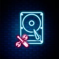 Glowing neon line Hard disk drive with screwdriver and wrench icon isolated on brick wall background. Adjusting, service Royalty Free Stock Photo