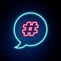 Glowing neon line Hashtag speech bubble icon isolated on brick wall background. Concept of number sign, social media