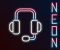 Glowing neon line Headphones icon isolated on black background. Support customer service, hotline, call center, faq Royalty Free Stock Photo