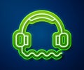 Glowing neon line Headphones icon isolated on blue background. Support customer service, hotline, call center, faq Royalty Free Stock Photo