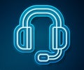 Glowing neon line Headphones icon isolated on blue background. Support customer service, hotline, call center, faq Royalty Free Stock Photo
