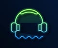 Glowing neon line Headphones icon isolated on blue background. Support customer service, hotline, call center, faq Royalty Free Stock Photo