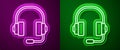 Glowing neon line Headphones icon isolated on purple and green background. Support customer service, hotline, call Royalty Free Stock Photo