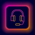 Glowing neon line Headphones with microphone icon isolated on black background. Colorful outline concept. Vector Royalty Free Stock Photo