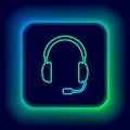 Glowing neon line Headphones with microphone icon isolated on black background. Concept object for listening to music Royalty Free Stock Photo