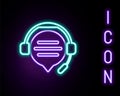 Glowing neon line Headphones with speech bubble chat icon isolated on black background. Support customer service Royalty Free Stock Photo