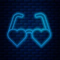 Glowing neon line Heart shaped love glasses icon isolated on brick wall background. Suitable for Valentine day card Royalty Free Stock Photo