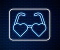 Glowing neon line Heart shaped love glasses icon isolated on brick wall background. Suitable for Valentine day card Royalty Free Stock Photo