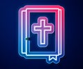 Glowing neon line Holy bible book icon isolated on blue background. Vector