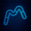 Glowing neon line Jelly worms candy icon isolated on brick wall background. Vector.