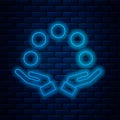 Glowing neon line Juggling ball icon isolated on brick wall background. Vector