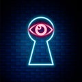 Glowing neon line Keyhole with eye icon isolated on brick wall background. The eye looks into the keyhole. Keyhole eye