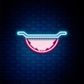 Glowing neon line Kitchen colander icon isolated on brick wall background. Cooking utensil. Cutlery sign. Colorful
