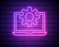 Glowing neon line Laptop and gear icon isolated on brick wall background. Laptop service concept. Adjusting app, setting options, Royalty Free Stock Photo