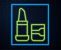 Glowing neon line Lipstick icon isolated on brick wall background. Vector