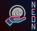Glowing neon line Mail and e-mail in hand icon isolated on black background. Envelope symbol e-mail. Email message sign Royalty Free Stock Photo