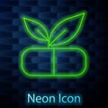 Glowing neon line Medical pill with plant icon isolated on brick wall background. Herbal pill. Vector