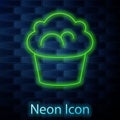 Glowing neon line Muffin icon isolated on brick wall background. Vector
