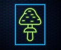 Glowing neon line Mushroom icon isolated on brick wall background. Vector