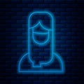 Glowing neon line Muslim woman in hijab icon isolated on brick wall background. Vector
