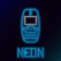 Glowing neon line Old vintage keypad mobile phone icon isolated on black background. Retro cellphone device. Vintage 90s Royalty Free Stock Photo