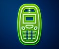 Glowing neon line Old vintage keypad mobile phone icon isolated on blue background. Retro cellphone device. Vintage 90s Royalty Free Stock Photo