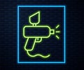 Glowing neon line Paint spray gun icon isolated on brick wall background. Vector Illustration. Royalty Free Stock Photo