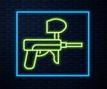 Glowing neon line Paintball gun icon isolated on brick wall background. Vector Illustration